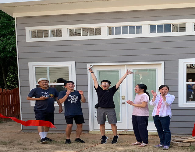 Wish kid Manny and his family posing in front of his new mancave