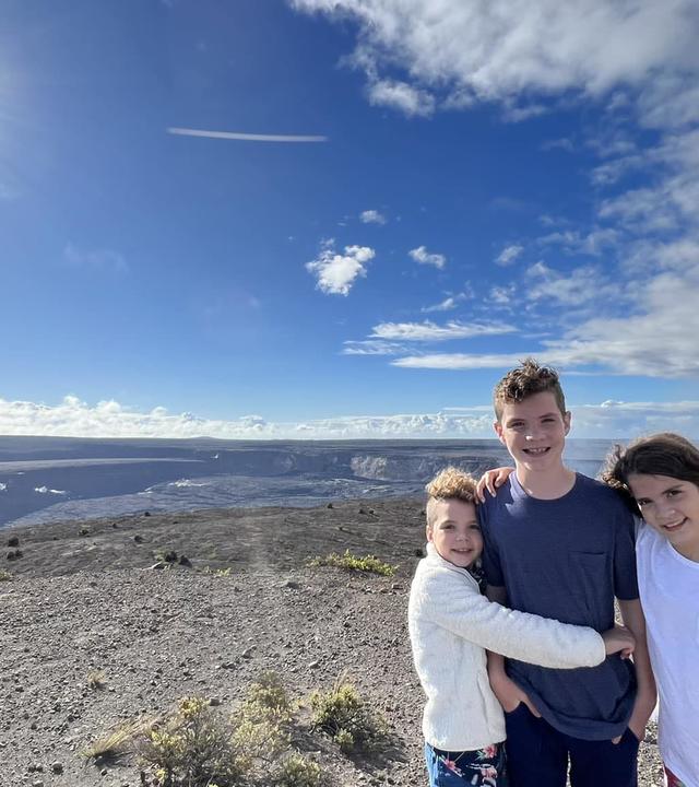 Wish kid Harrison with his siblings on the top of a volcano