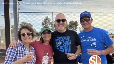 Wish granter Jose Durazo stands with fellow volunteers who help grant wishes.