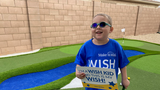 Wish kid Andrew in backyard standing in front of his new golf course
