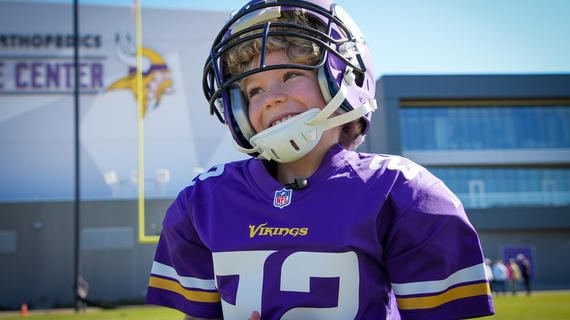 Charlie wears his Vikings uniform before heading to practice with the team.